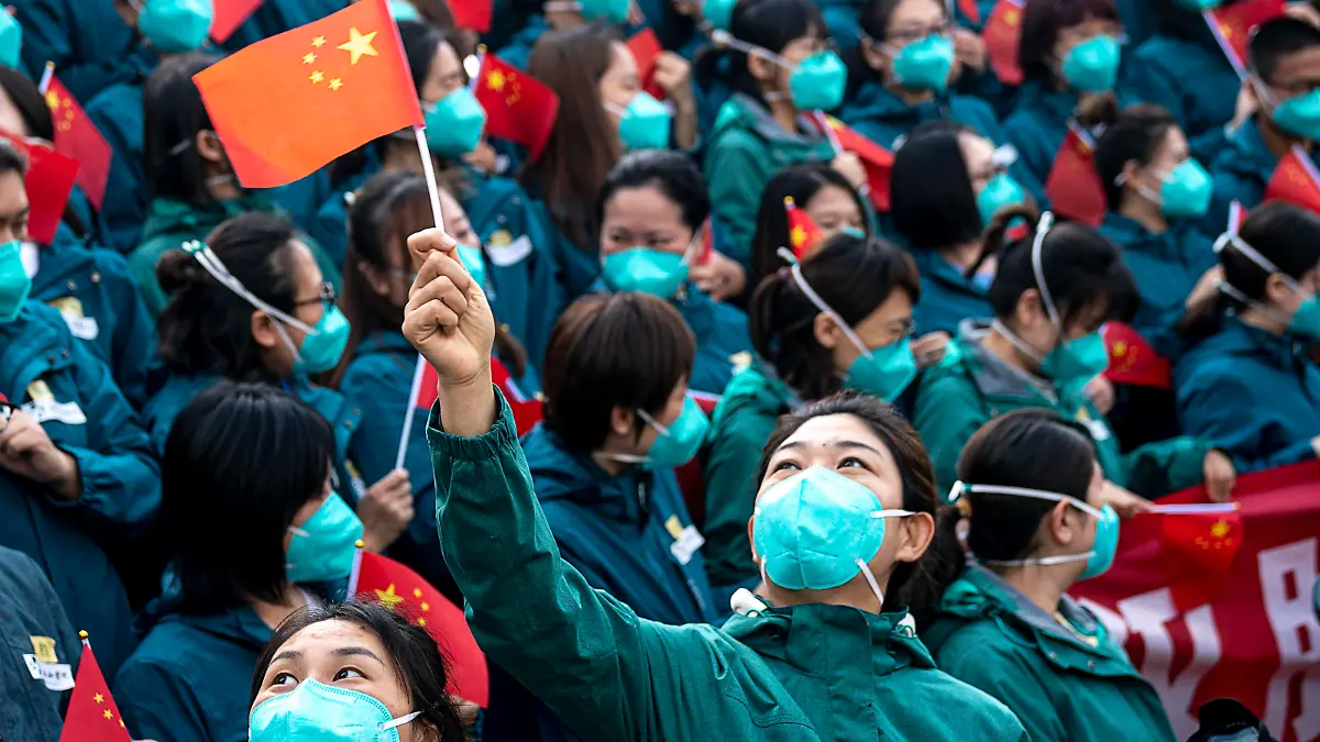  200415 -- WUHAN, April 15, 2020 -- A medical worker from the Peking Union Medical College Hospital waves the Chinese national flag in Wuhan, capital of central China s Hubei Province, April 15, 2020. The last medical assistance team started leaving Hubei Province Wednesday as the COVID-19 epidemic in the hard-hit province has been subdued. The medical team consisting of over 180 medical workers from the Peking Union Medical College Hospital arrived in the provincial capital of Wuhan on Jan. 26.  CHINA-HUBEI-WUHAN-LAST MEDICAL ASSISTANCE TEAM-LEAVING CN XiongxQi PUBLICATIONxNOTxINxCHN