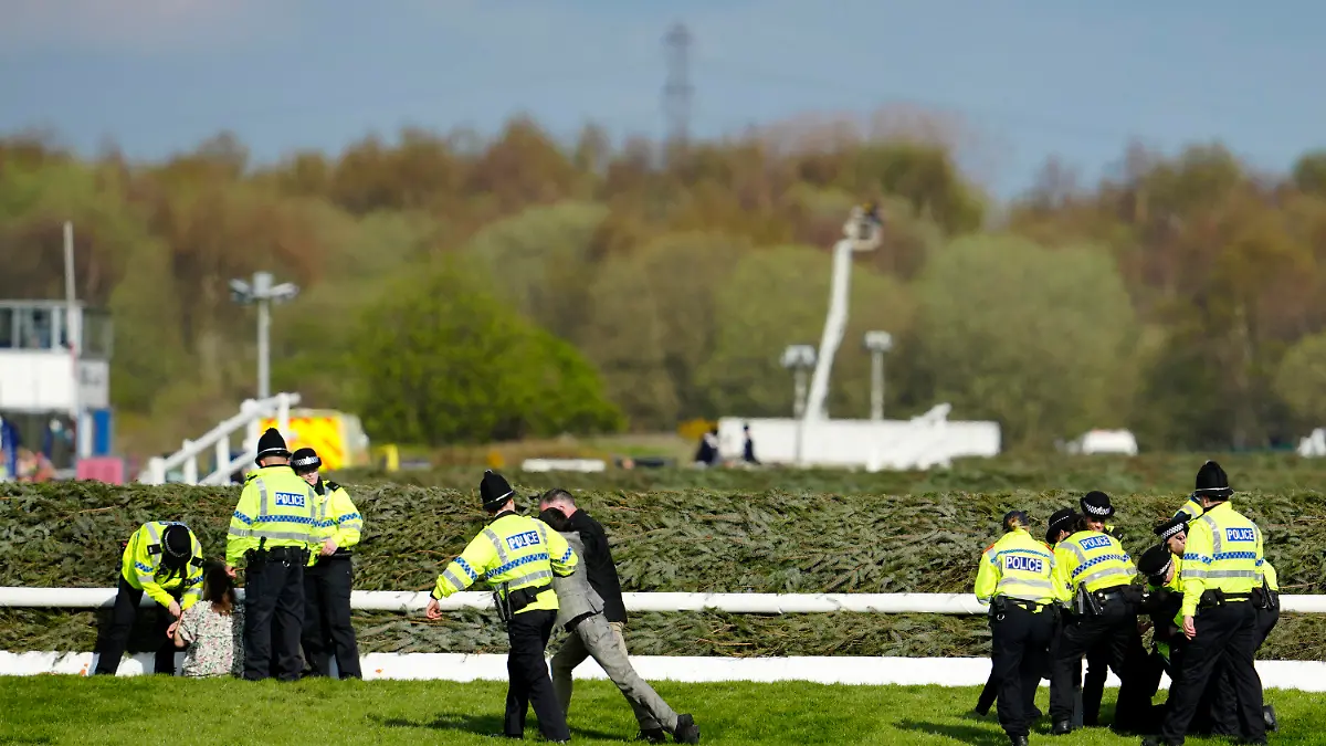 Members of the police forces remove protesters as they tried to block the start of the Grand National horse race at Aintree Racecourse Liverpool, England, Saturday, April 15, 2023. The iconic Grand National race which is run over fences is 4 miles, 2 ½ furlongs has its origins in the 1839 Grand Liverpool Steeplechase.(AP Photo/Jon Super)