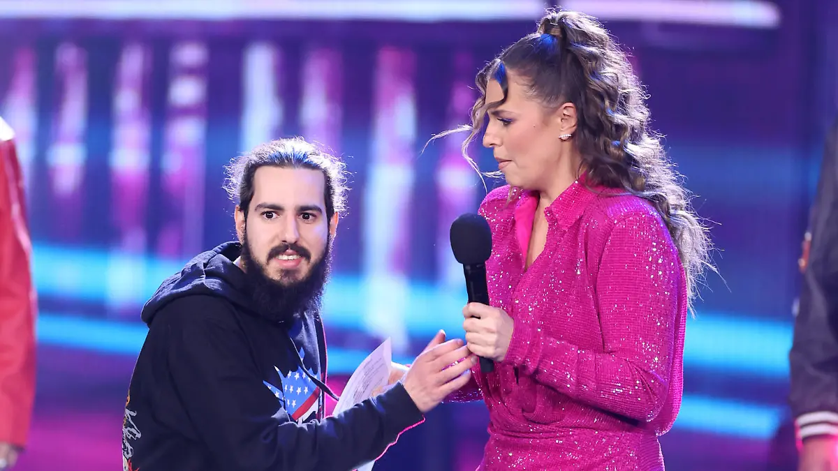 COLOGNE, GERMANY - APRIL 15: A member of the audience goes up on stage uninvited and tries to take the mic from show host Laura Wontorra during the finals of the tv competition show "Deutschland sucht den Superstar" ( DSDS ) at MMC Studios on April 15, 2023 in Cologne, Germany. (Photo by Andreas Rentz/Getty Images)