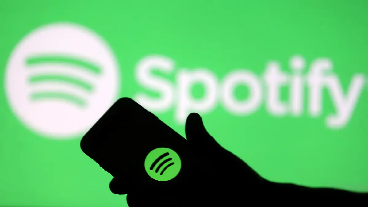 FILE PHOTO: A smartphone is seen in front of a screen projection of Spotify logo, in this picture illustration taken April 1, 2018. REUTERS/Dado Ruvic/Illustration/File Photo GLOBAL BUSINESS WEEK AHEAD