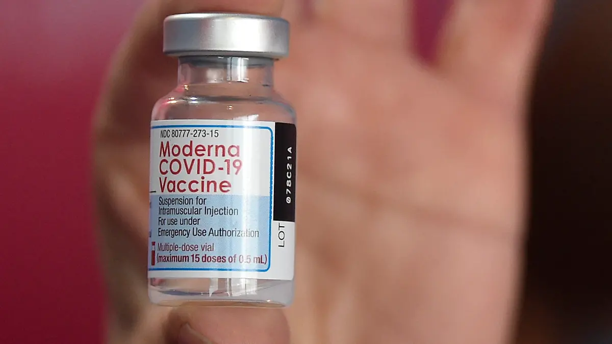 A health worker shows a vial of the Moderna vaccine for COVID-19, donated by the US government, at a health center in Quilmes, Argentina, Tuesday, Aug. 3, 2021. Argentina is vaccinating youths with pre-existing conditions, between ages 12 and 17. ​(AP Photo/Gustavo Garello)