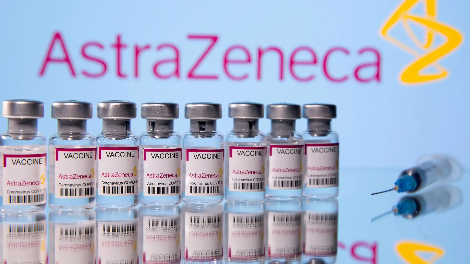 FILE PHOTO: Vials labelled "Astra Zeneca COVID-19 Coronavirus Vaccine" and a syringe are seen in front of a displayed AstraZeneca logo, in this illustration photo taken March 14, 2021. REUTERS/Dado Ruvic/Illustration/File Photo
