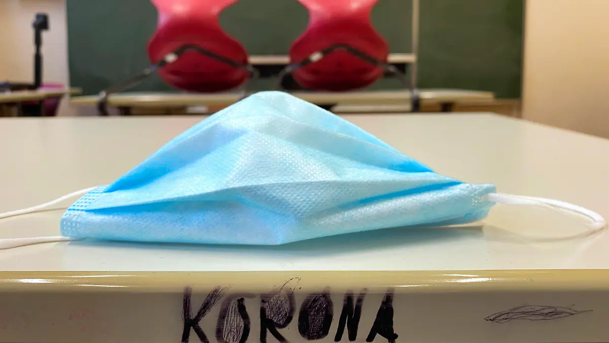  leeres Klassenzimmer, aufgestuhlt, Mundschutzmaske und Schriftzug KORONA auf Tisch, Einzeltische ohne Abstandsregel, Corona-Krise, Deutschland Leeres Klassenzimmer Corona-Krise *** Empty classroom, seated, face mask and lettering KORONA on table, single tables without distance rule, Corona crisis, Germany Empty classroom Corona crisis