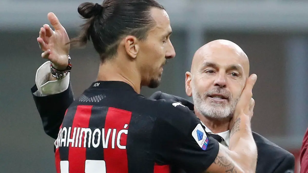 AC Milan's manager Stefano Pioli embraces Zlatan Ibrahimovic at the end of the Serie A soccer match between Inter Milan and AC Milan at the San Siro Stadium, in Milan, Italy, Saturday, Oct. 17, 2020. Ibrahimovic scored both goals in AC Milan 2 - 1 victory. (AP Photo/Antonio Calanni)