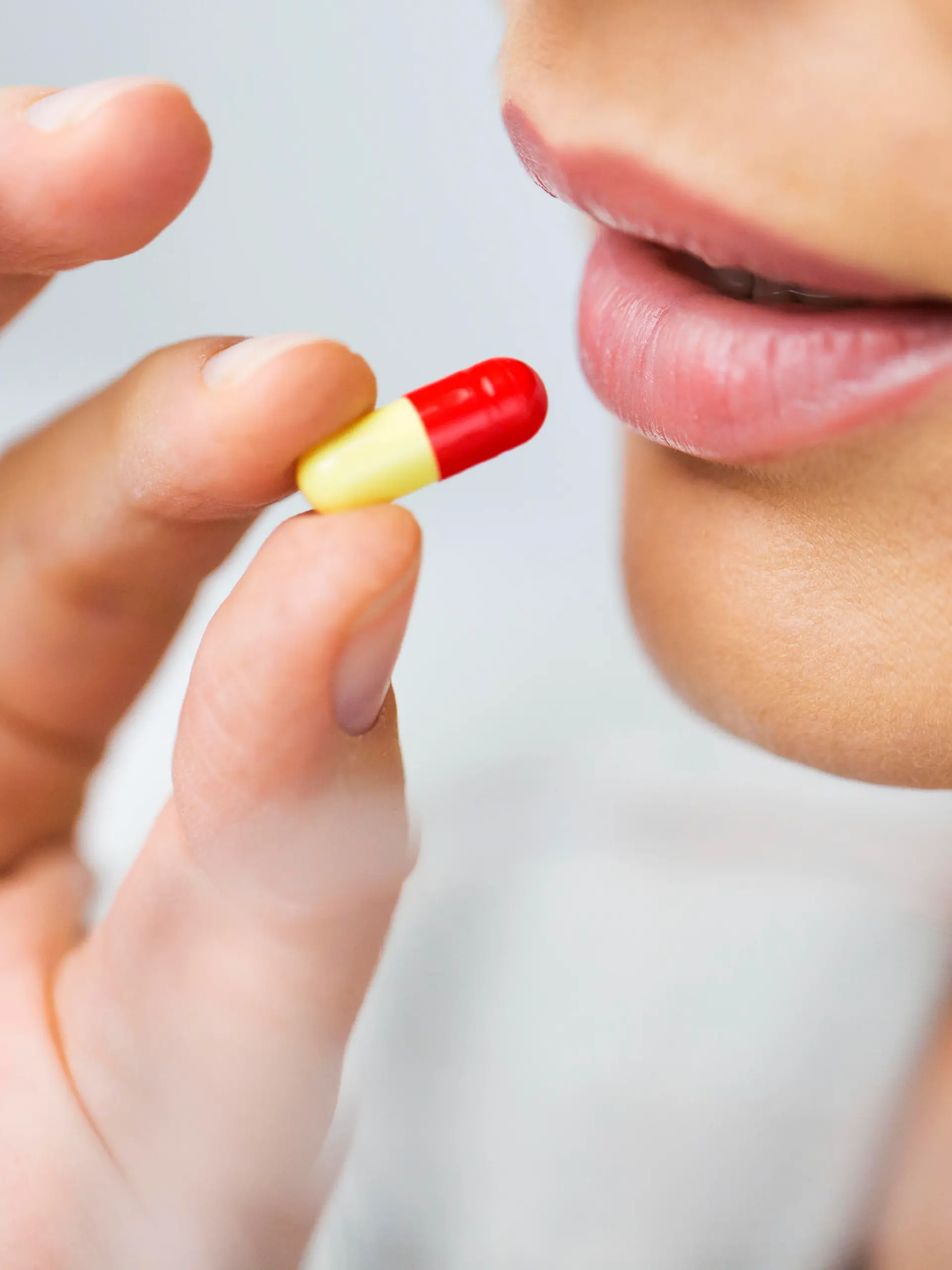 medicine, health care and people concept - close up of woman taking in pill