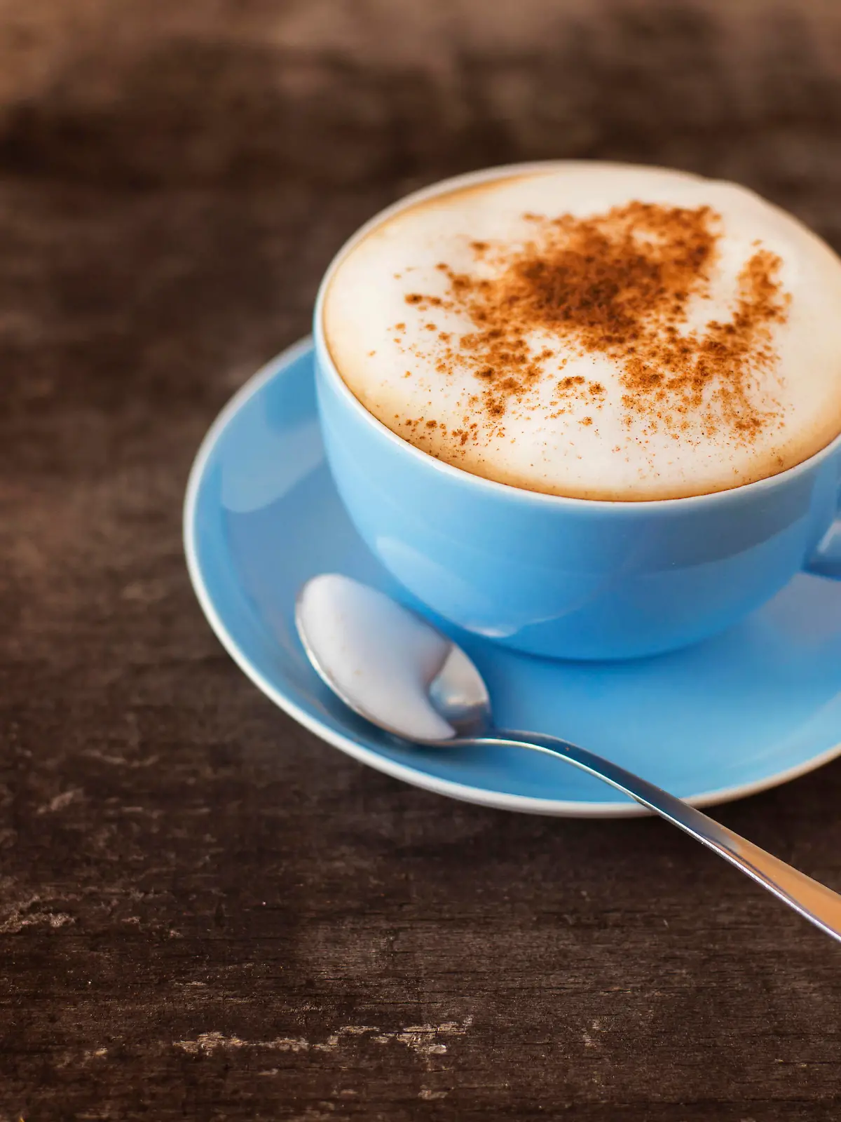 Cup of coffee on a wooden table background