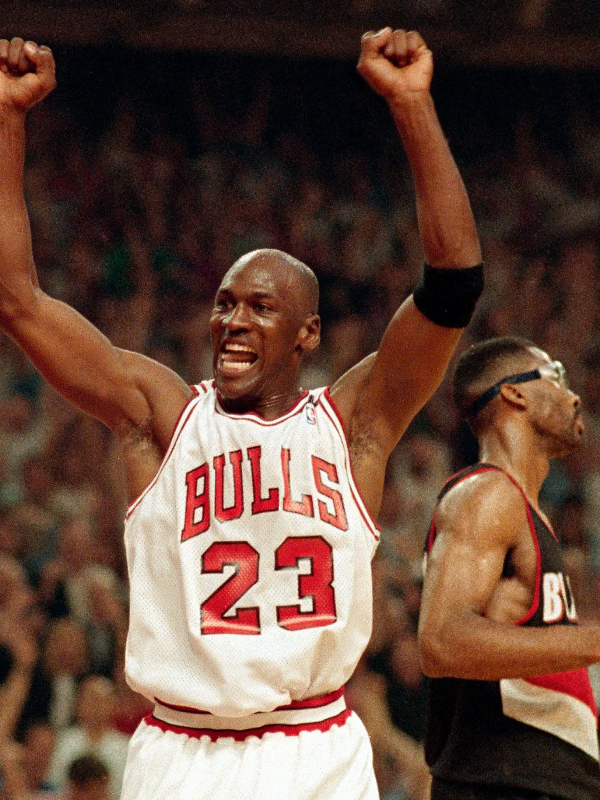 FILE - In this June 14, 1992, file photo, Michael Jordan celebrates the Bulls win over the Portland Trail Blazers in the NBA Finals in Chicago. Decades after Jordan's groundbreaking departure from college, March Madness and the NBA's mega-millions have taken all the novelty out of leaving early for the pros. (AP Photo/John Swart, File)
