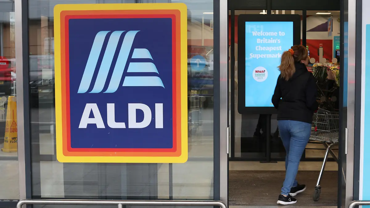 A shopper walks inside an ALDI supermarket near Altrincham, Britain, February 20, 2023. REUTERS/Phil Noble