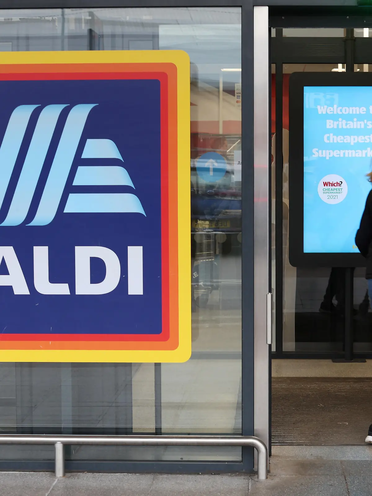 A shopper walks inside an ALDI supermarket near Altrincham, Britain, February 20, 2023. REUTERS/Phil Noble