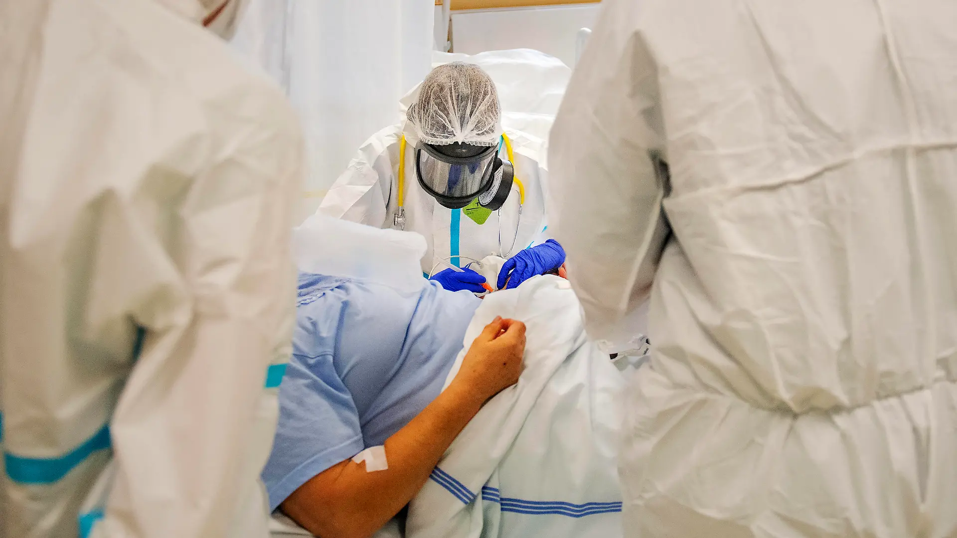 Doctor Kristina Sukova with protective clothing cares for a patient in the intensive care unit ICU for patients with COVID-19 disease in the Pribram Regional Hospital, Czech Republic, on October 23, 2020. CTKxPhoto/MiroslavxChaloupka CTKPhotoP202010230557901 cha0011