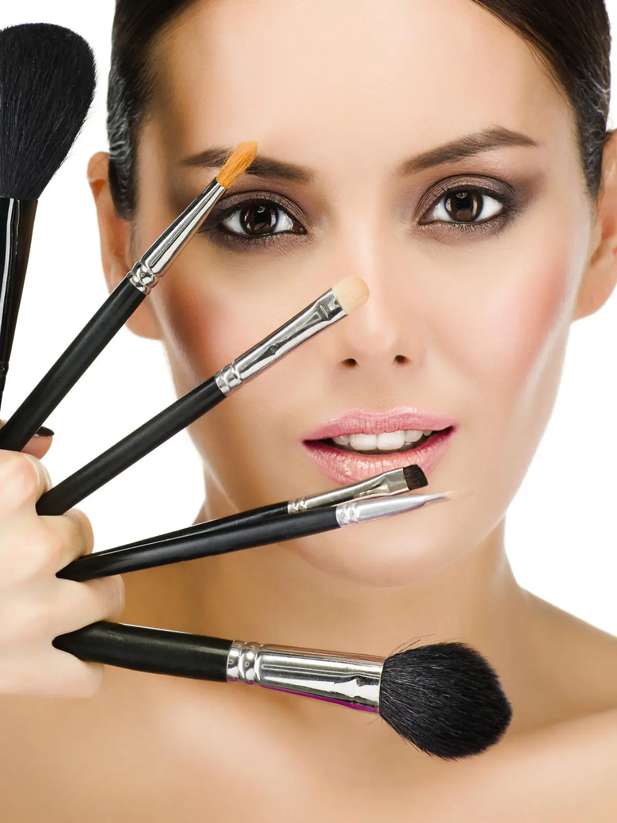 portrait of attractive  caucasian  woman brunette isolated on white studio shot looking at camera face skin makeup closeup brushes