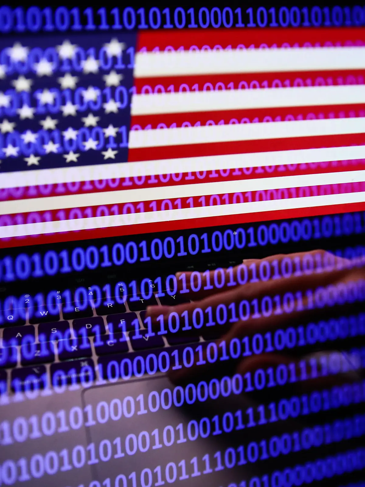 Flag of the United States displayed on a laptop screen and binary code displayed on a screen are seen in this multiple exposure illustration photo taken in Krakow, Poland on September 27, 2022. (Photo by Jakub Porzycki/NurPhoto)