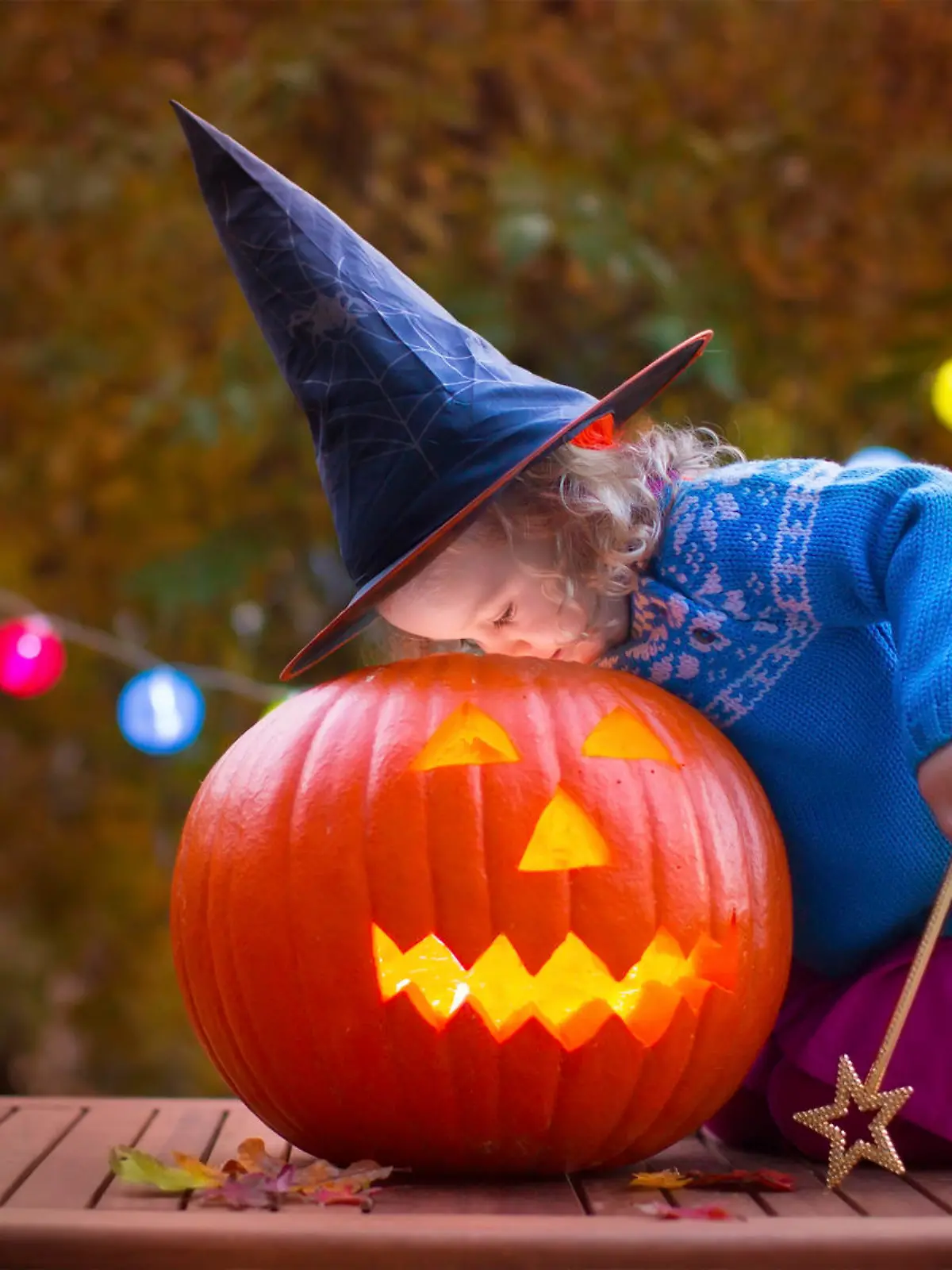 Little girl and boy carving pumpkin at Halloween. Dressed up children trick or treating. Kids trick or treat. Child in witch costume playing in autumn park. Toddler kid with jack-o-lantern.