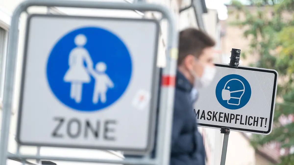 21.10.2020, Baden-Württemberg, Heilbronn: Ein Mann geht in der Fußgängerzone vor einem Schild vorbei, auf dem "Maskenpflicht" steht. Die Stadt Heilbronn hat mit einem Wert von 115,3 den höchsten Sieben-Tage-Inzidenz-Wert bei nachgewiesenen Coronainfektionen im Bundesland. Foto: Sebastian Gollnow/dpa +++ dpa-Bildfunk +++