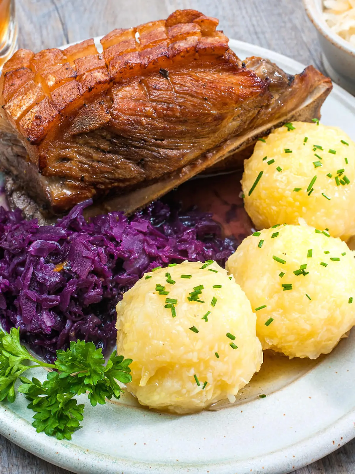 Appetizing Bavarian roast pork dish with dumplings and pretzel