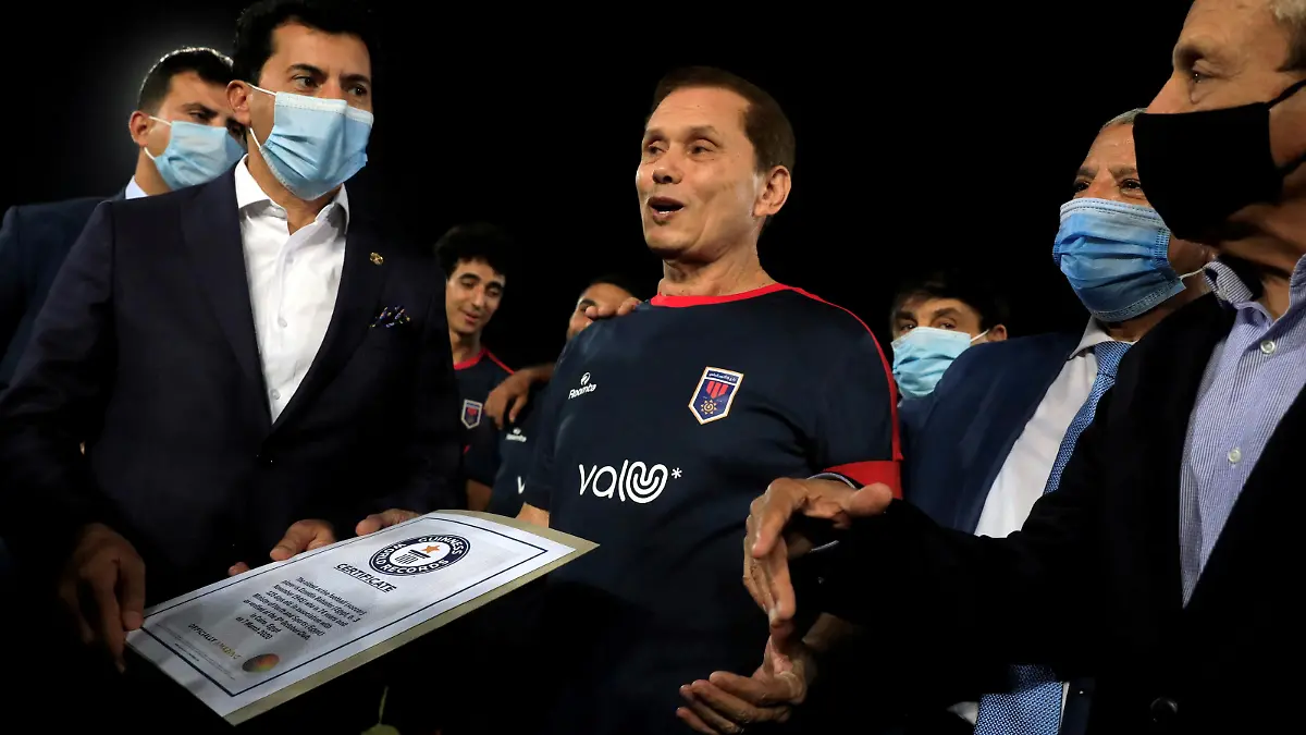 Ezzeldin Bahader, a 74-years-old Egyptian football player of 6th October Club talks with Dr. Ashraf Sobhi, Minister of Youth and Sports wearing a protective face mask due to the coronavirus disease (COVID-19) outbreak before a soccer match against El Ayat Sports Club of Egypt's third division league at the Olympic Stadium in the Cairo suburb of Maadi, Egypt October 17, 2020. Picture taken October 17, 2020. REUTERS/Amr Abdallah Dalsh   REFILE - CORRECTING AGE