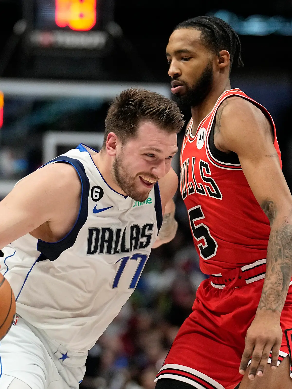 Dallas Mavericks guard Luka Doncic (77) works to shoot against Chicago Bulls forward Derrick Jones Jr., right, in the first half of an NBA basketball game Friday, April 7, 2023, in Dallas. (AP Photo/Tony Gutierrez)