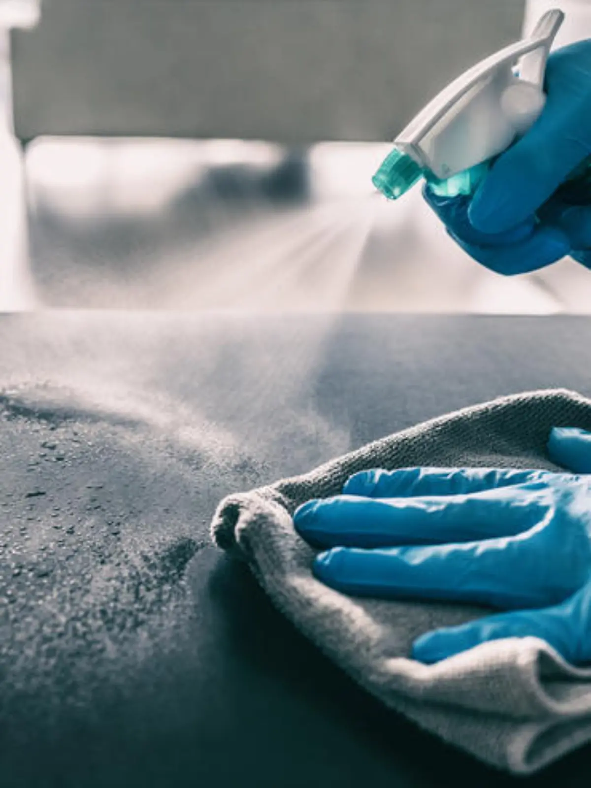 Surface sanitizing against COVID-19 outbreak. Home cleaning spraying antibacterial spray bottle disinfecting against coronavirus wearing nitrile gloves. Sanitize hospital surfaces prevention. (Surface sanitizing against COVID-19 outbreak. Home cleani