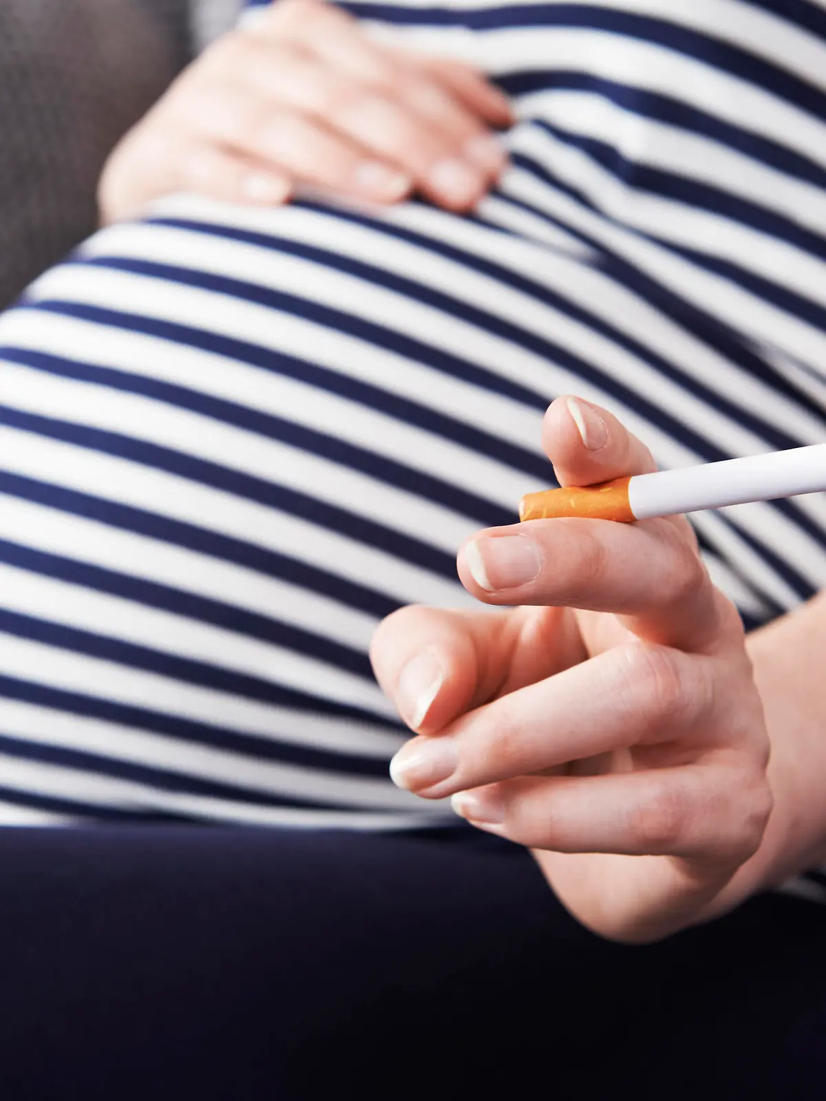 Close Up Of Pregnant Woman Smoking Cigarette