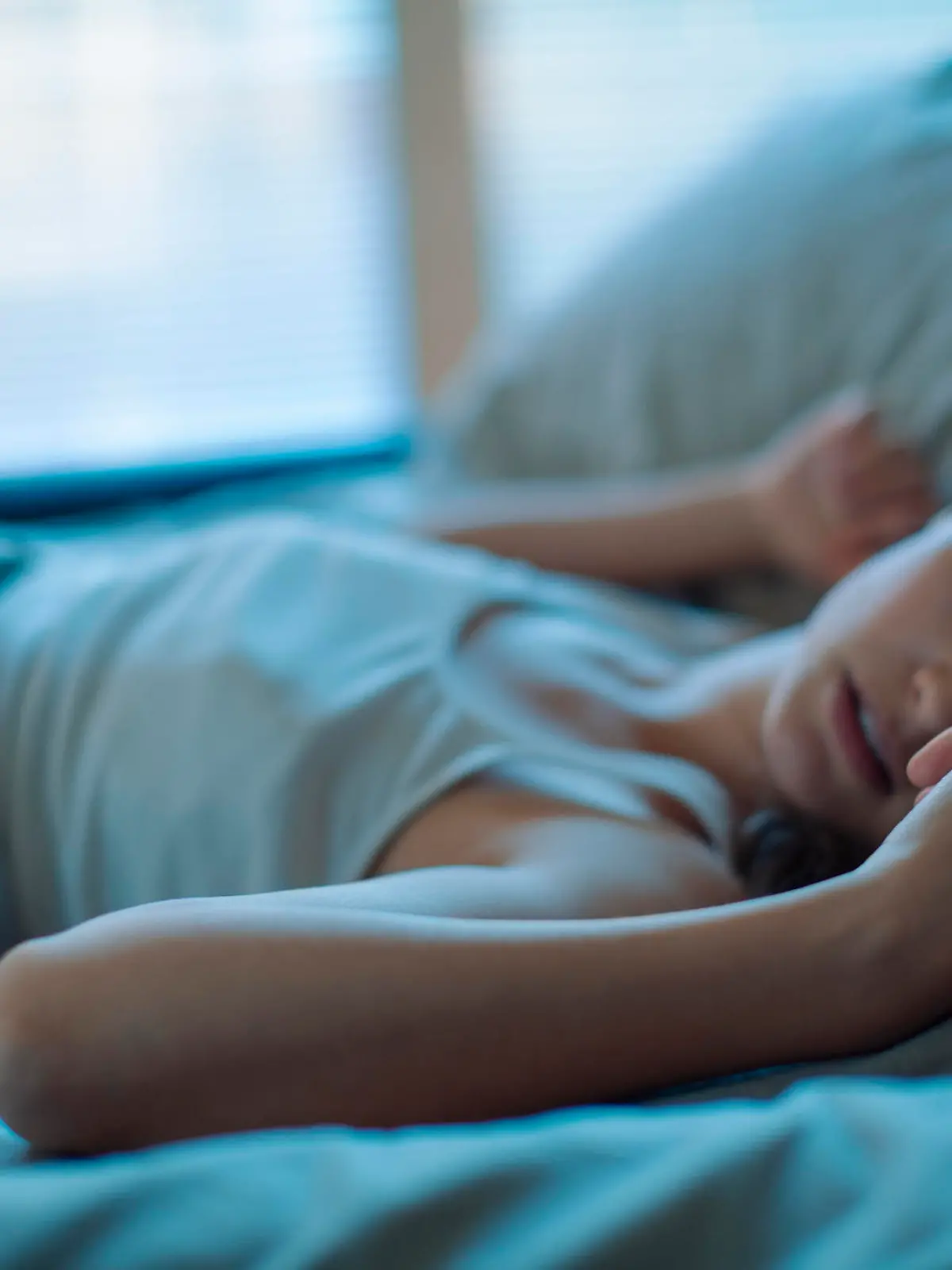 Close up of a woman sleeping on the bed