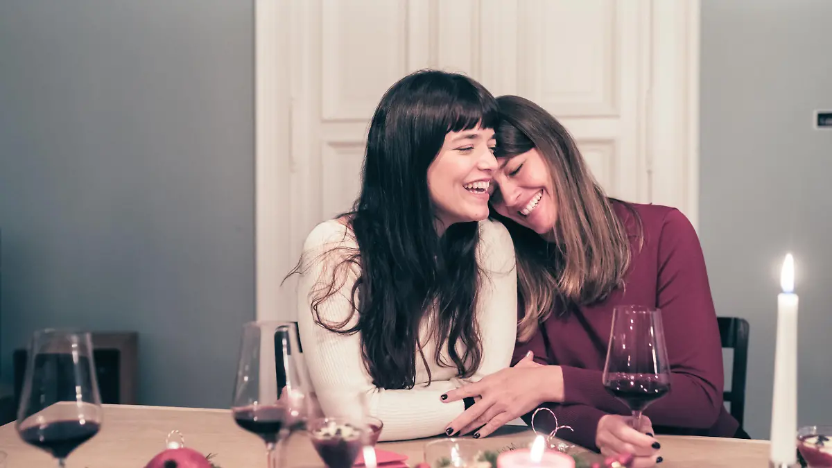 young beautiful sibling sisters close together at christmas table