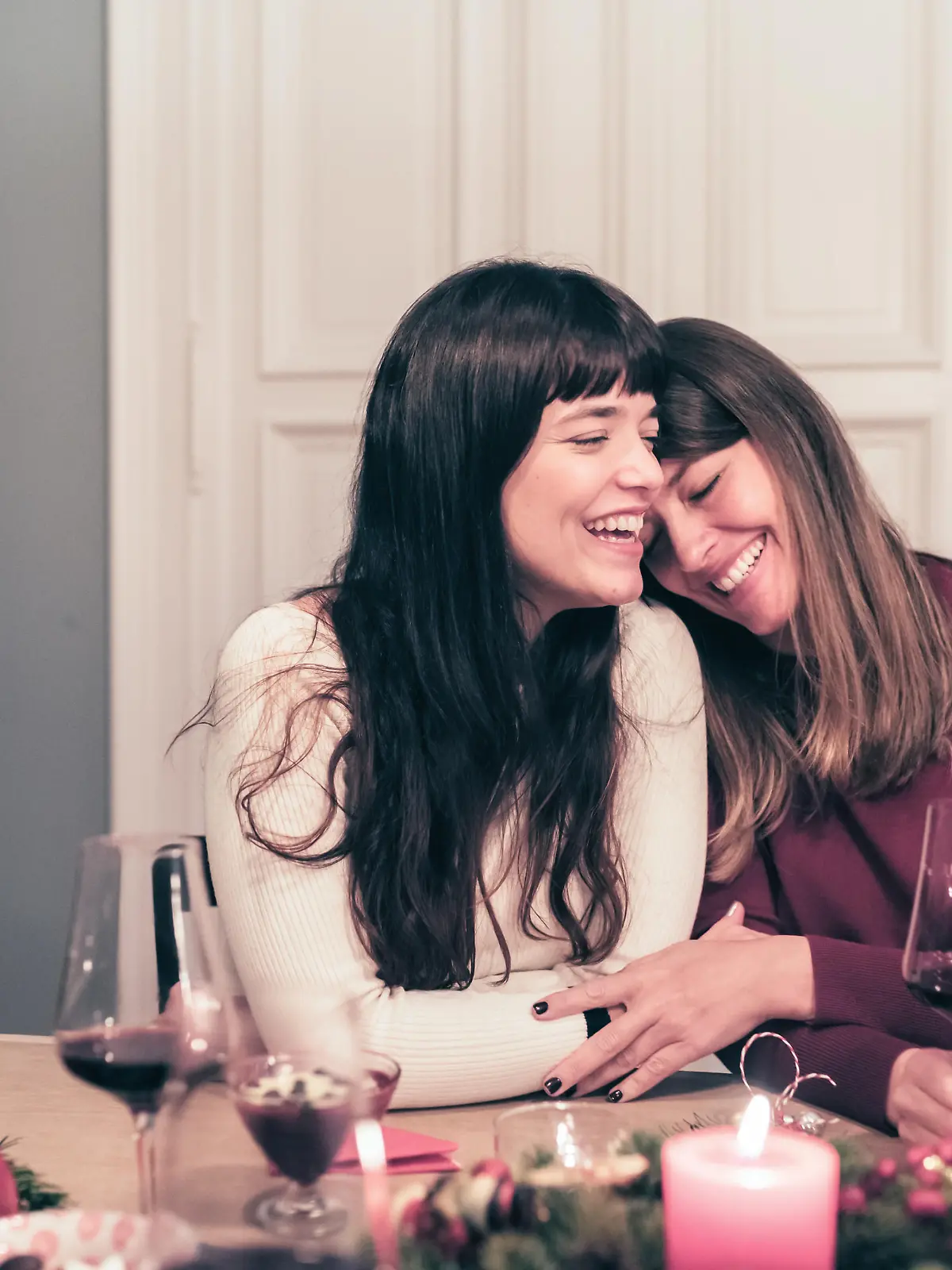 young beautiful sibling sisters close together at christmas table