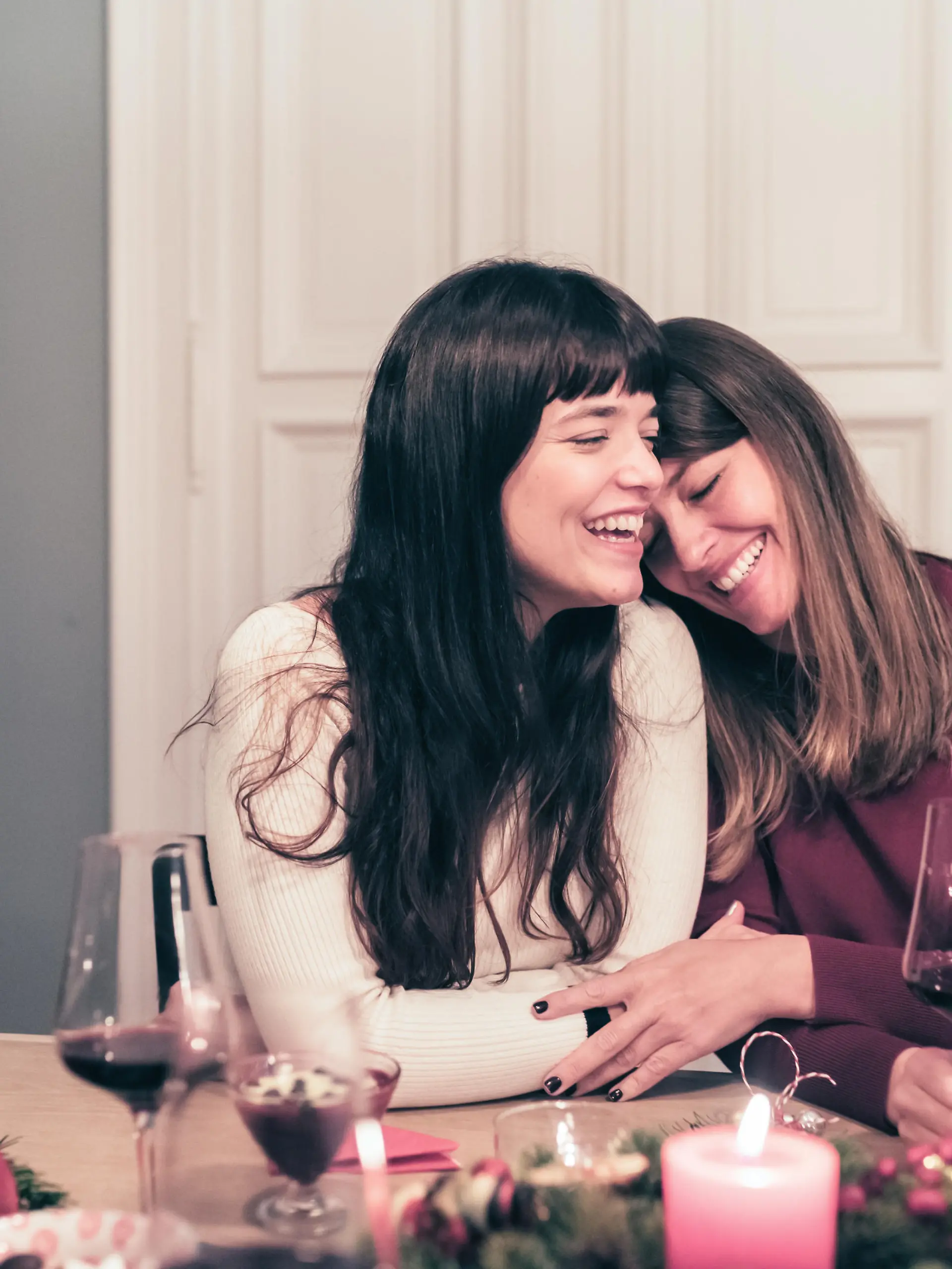 young beautiful sibling sisters close together at christmas table