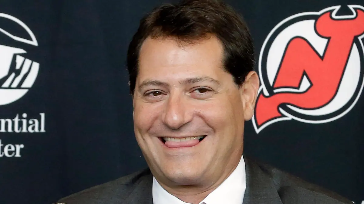 FILE - David Blitzer smiles during a New Jersey Devils NHL hockey press conference in Newark, N.J., Thursday, Aug. 15, 2013. The Cleveland Guardians have had “meaningful” discussions with David Blitzer, a part owner of the Philadelphia 76ers and New Jersey Devils, to become a minority owner with the Major League Baseball team. (AP Photo/Julio Cortez, File)