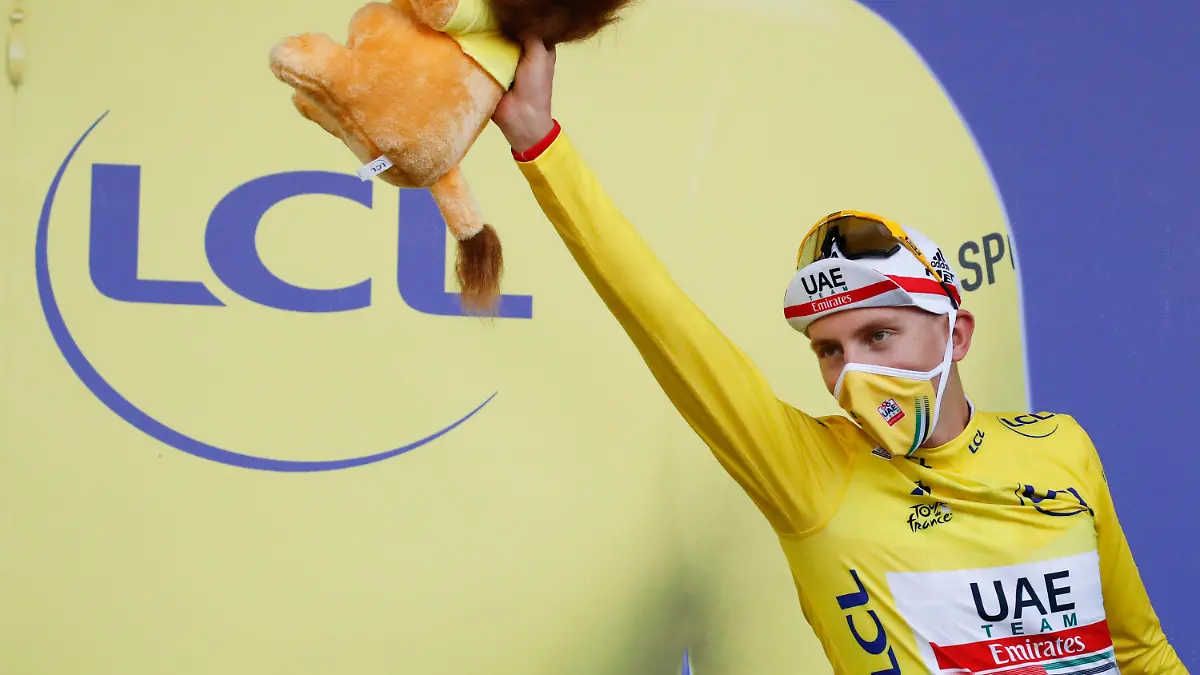 Stage winner and new overall leader, best young rider and best climber, Slovenia's Tadej Pogacar, wearing the yellow jersey, celebrates on the podium after stage 20 of the Tour de France cycling race, an individual time trial over 36.2 kilometers (22.5 miles), from Lure to La Planche des Belles Filles, France, Saturday, Sept. 19, 2020. (Sebastien Nogier/Pool via AP)