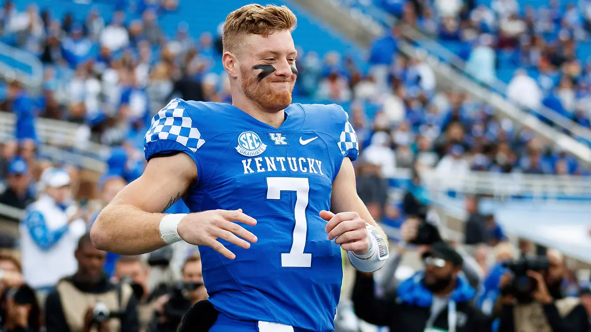 Kentucky quarterback Will Levis runs to greet head coach Mark Stoops during a senior day celebration before an NCAA college football game against Louisville in Lexington, Ky., Saturday, Nov. 26, 2022. (AP Photo/Michael Clubb)