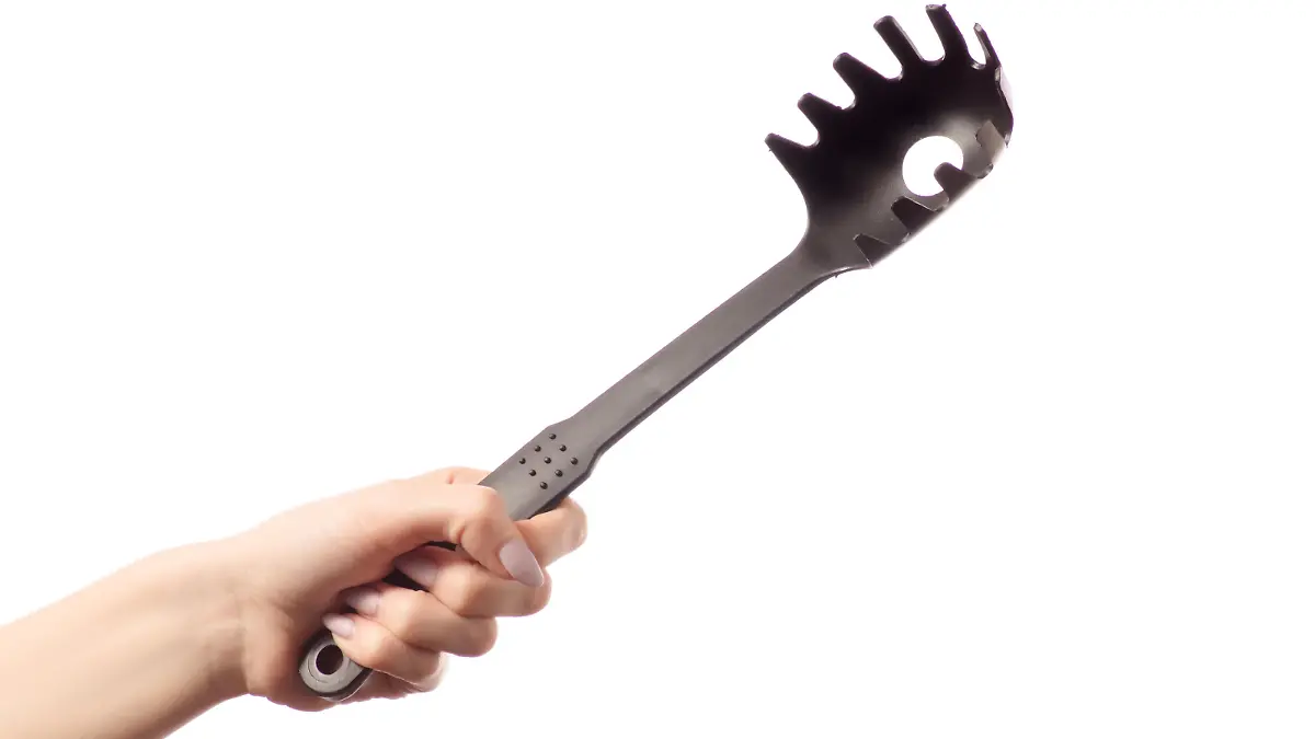 Spaghetti spatula in hands isolated on white background isolation