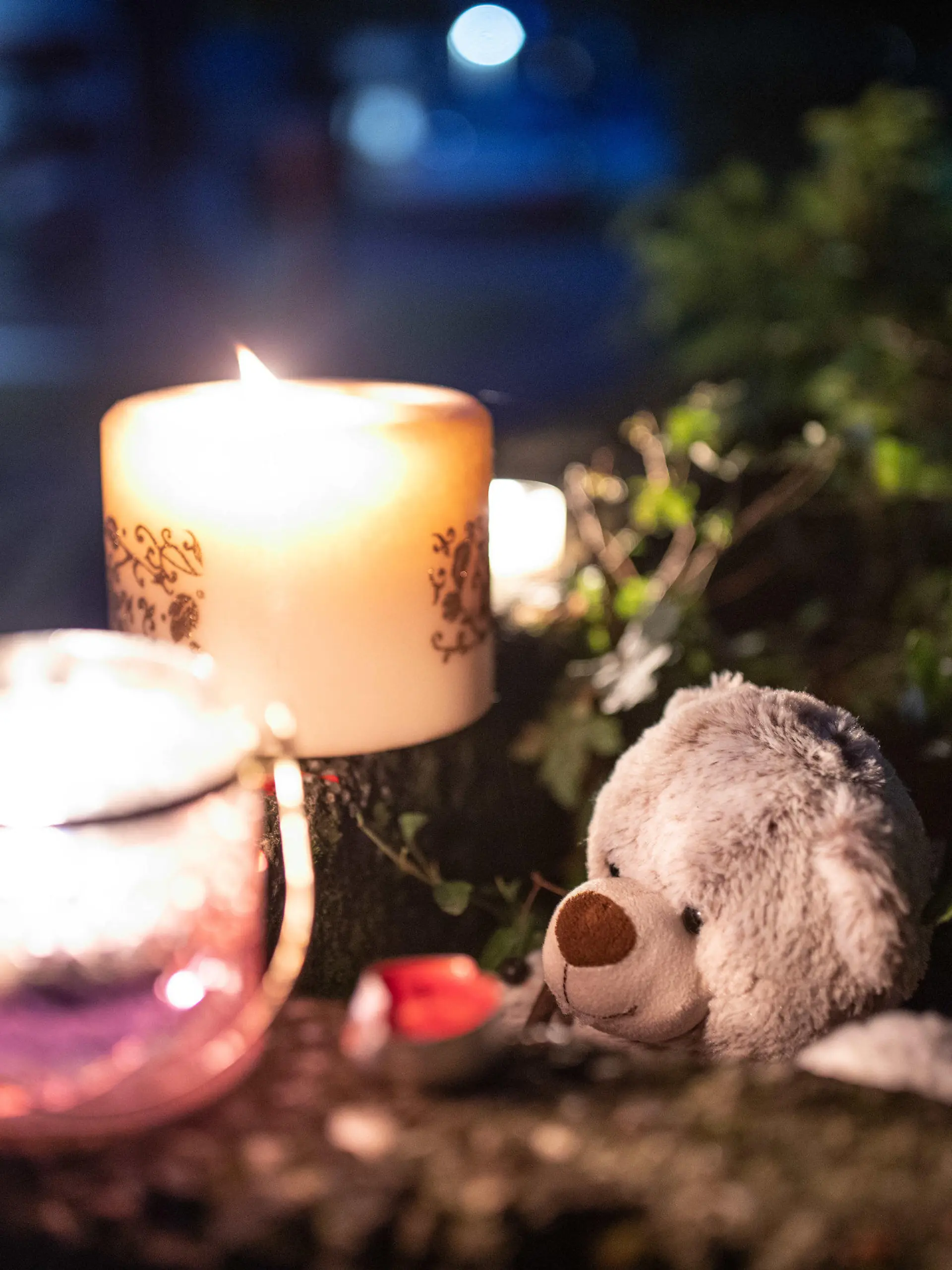 04.09.2020, Nordrhein-Westfalen, Solingen: Ein Teddybär und Kerzen liegen und stehen vor einem  Haus. Eine 27-jährige Mutter soll in Solingen fünf Kinder umgebracht haben. Die Mutter habe sich danach im Düsseldorfer Hauptbahnhof auf die Gleise begeben, aber verletzt überlebt. Foto: Marcel Kusch/dpa +++ dpa-Bildfunk +++