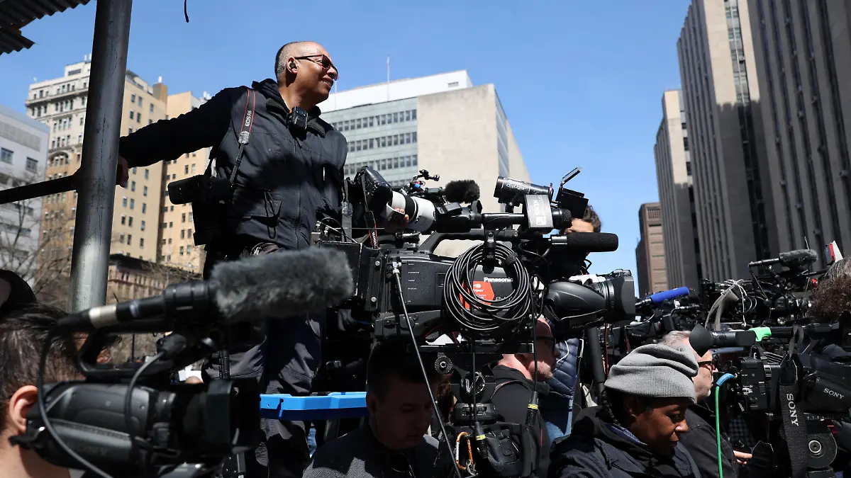 Members of the media gather outside Manhattan Criminal Courthouse on the day of former U.S. President Donald Trump's court appearance after his indictment by a Manhattan grand jury following a probe into hush money paid to porn star Stormy Daniels, in New York City, U.S., April 4, 2023. REUTERS/Caitlin Ochs