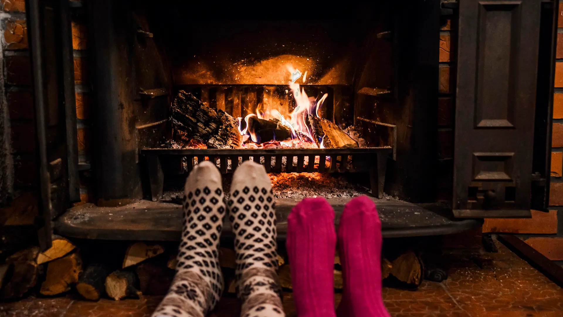 Feet in wool socks warming by cozy fire