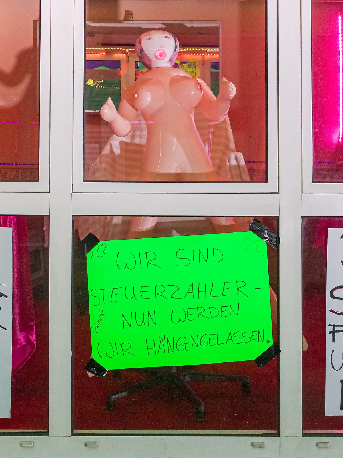 11.07.2020, Hamburg: An dem Fenster eines Bordells in der Herbertstraße hängen Transparente mit den Aufschriften «Gute Steuerzahler, mehr auch nicht», «Wir sind Steuerzahler, nun werden wir hängengelassen» und «Der Staat fickt uns und zahlt nichts!». Prostituierte demonstrieren für die Öffnung der Bordelle auf St. Pauli. Diese sind zur Eindämmung der Corona-Pandemie momentan geschlossen. Foto: Markus Scholz/dpa +++ dpa-Bildfunk +++