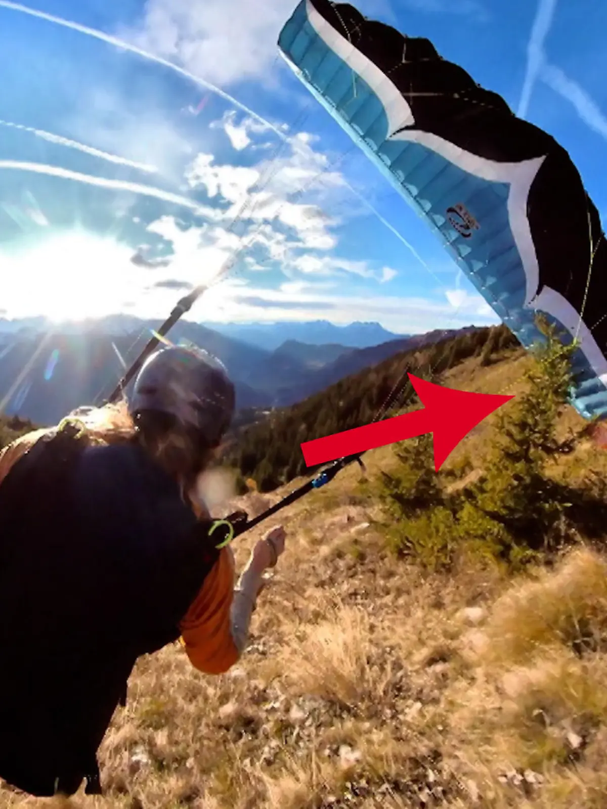 Das hat sich dieser Paraglider wohl etwas anders vorgestellt. Nach einem waghalsigen Stunt bleibt er mit dem Schirm an einem Busch hängen.
