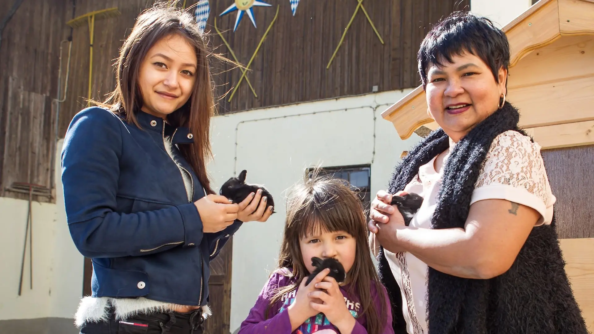 Jorafina (5) zeigt ihrer Mama Narumol (r.) und ihrer großen Halbschwester Jenny (18) stolz den neuen Familienzuwachs: Kleine, putzige Kaninchen bevölkern jetzt zusätzlich den Hof. Josef hat extra eigene neue Ställe für die flauschigen Vierbeiner gebaut.