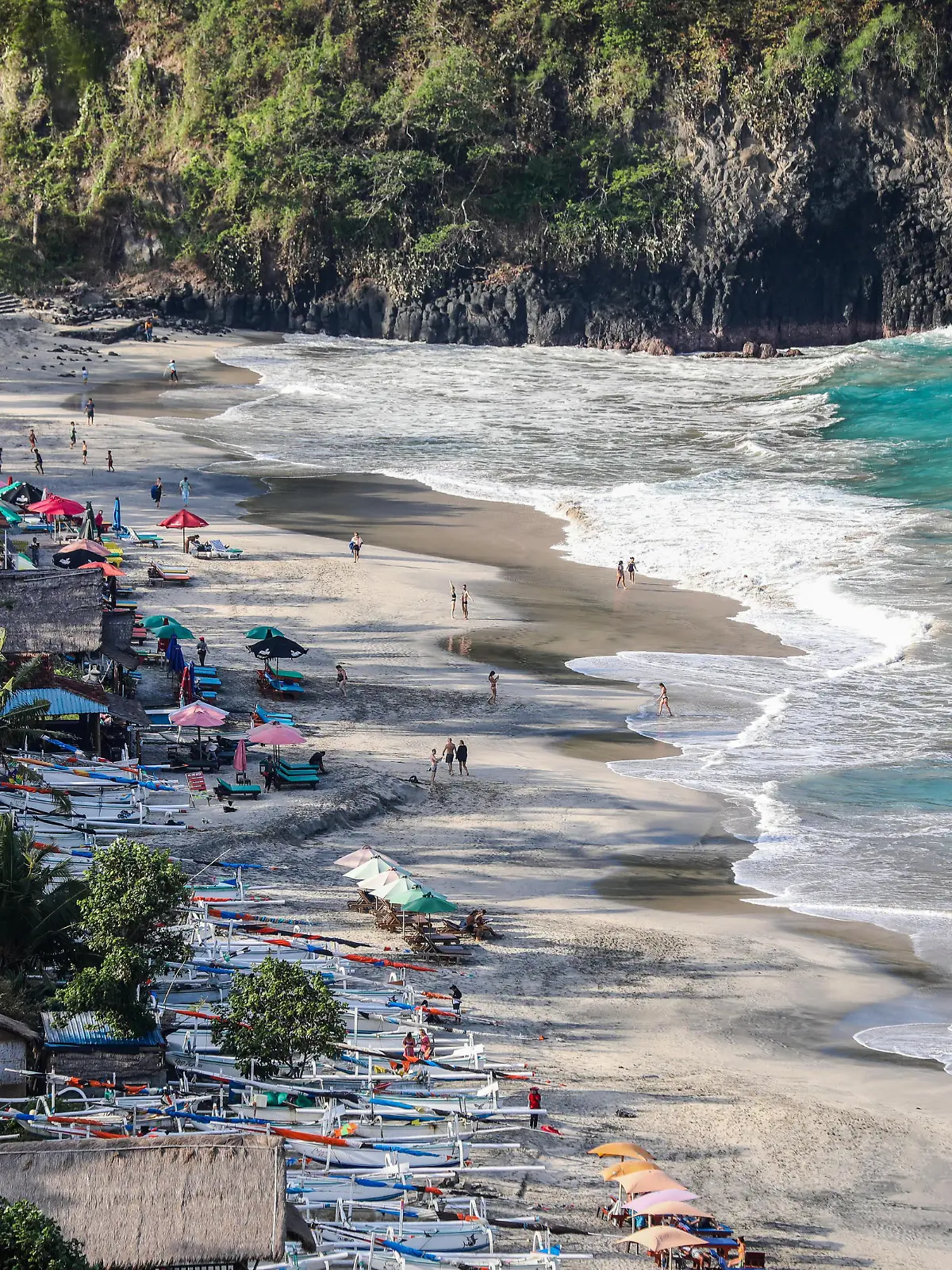 People enjoy at the beach in Candidasa, Bali, Indonesia, on September 1, 2022. (Photo by Garry Lotulung/NurPhoto)