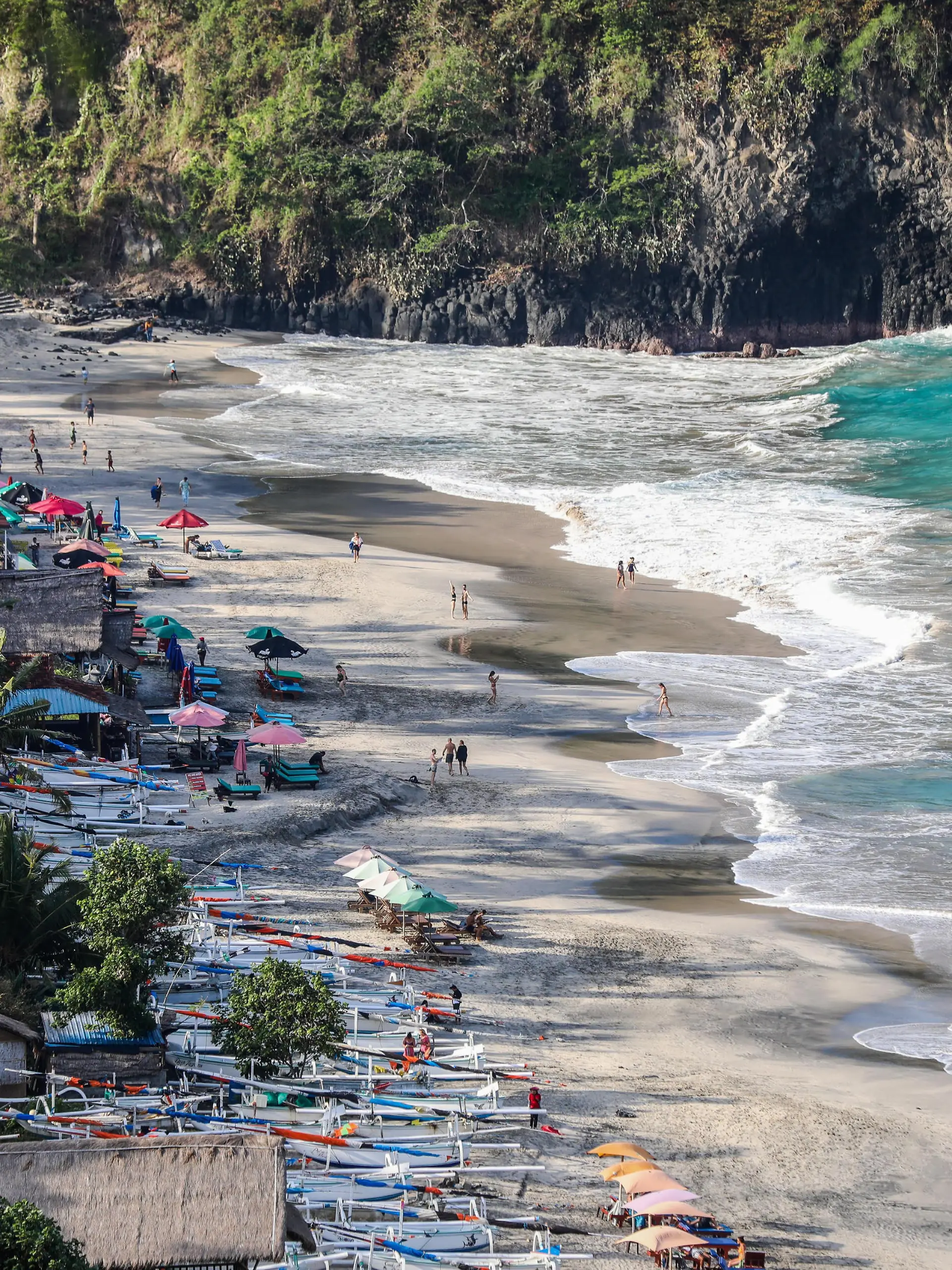 People enjoy at the beach in Candidasa, Bali, Indonesia, on September 1, 2022. (Photo by Garry Lotulung/NurPhoto)