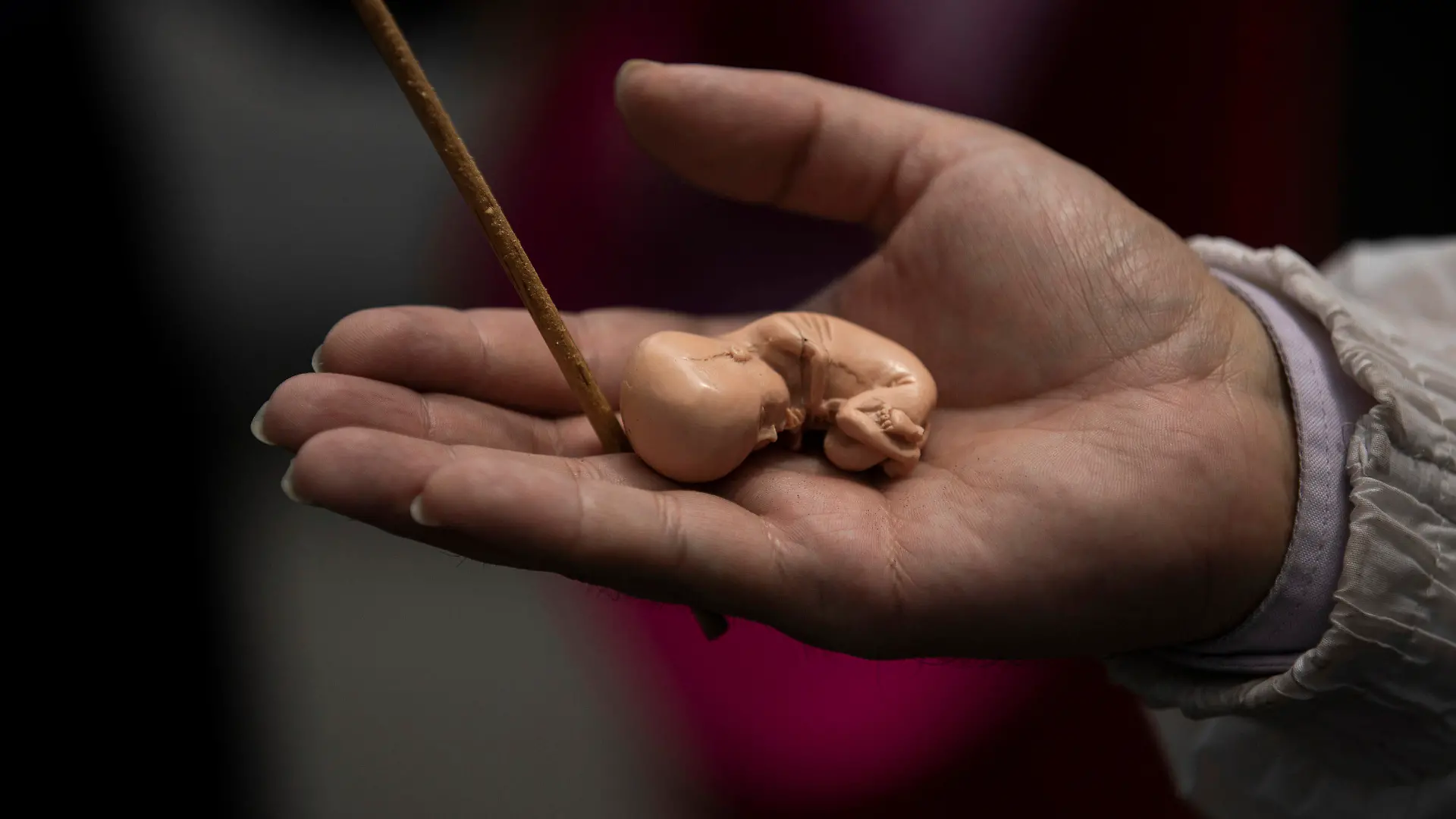 An activists against abortion holds a model of a fetus outside of Mexico's Supreme Court steps during a protest in Mexico City, Tuesday, July 28, 2020. The activists protest as Mexico's Supreme Court is expected to rule on a case regarding a Veracruz state law prohibiting abortion except in cases of rape, if the mother's life is in danger, or if the unborn baby is malformed. (AP Photo/Fernando Llano)
