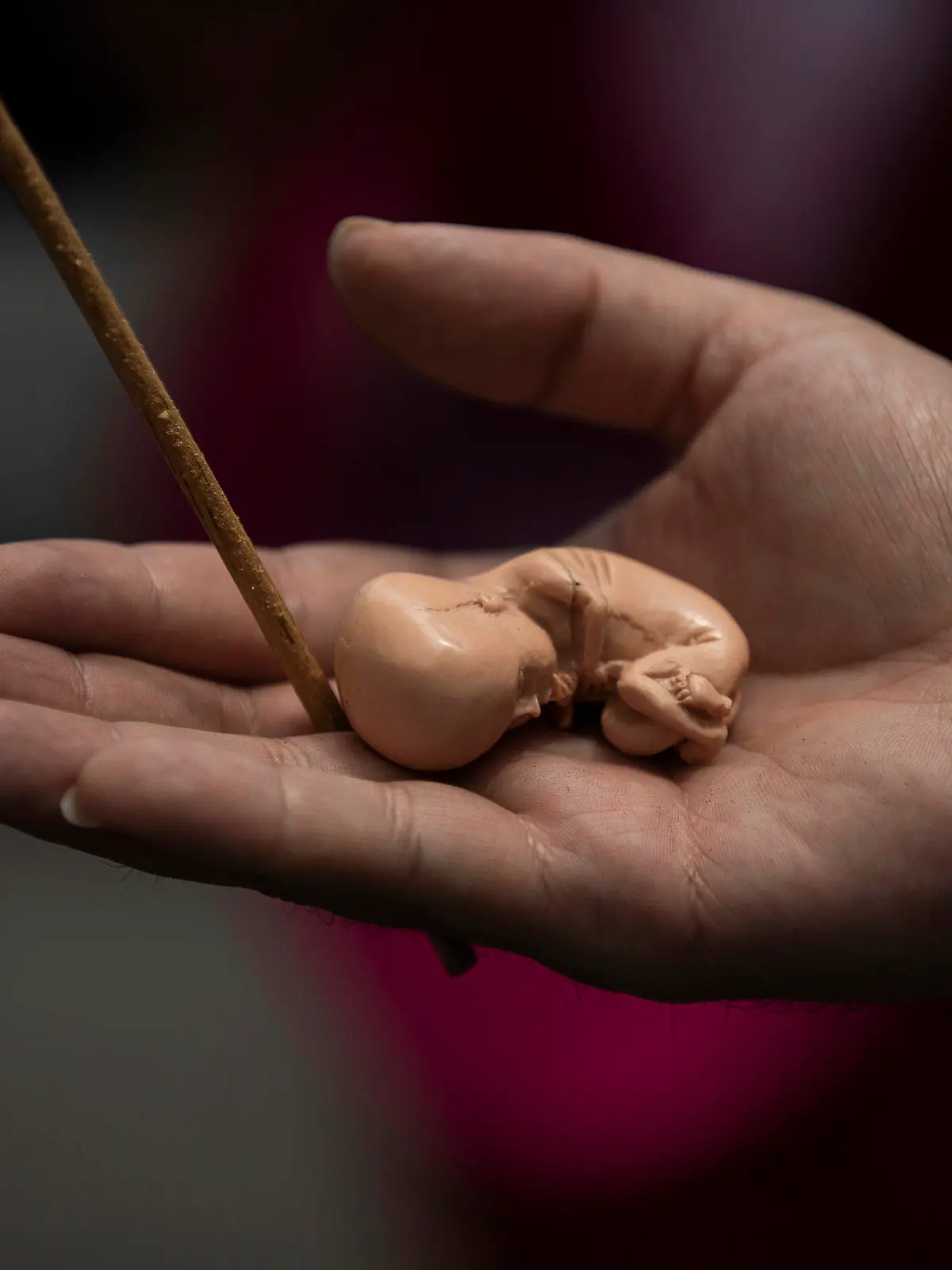 An activists against abortion holds a model of a fetus outside of Mexico's Supreme Court steps during a protest in Mexico City, Tuesday, July 28, 2020. The activists protest as Mexico's Supreme Court is expected to rule on a case regarding a Veracruz state law prohibiting abortion except in cases of rape, if the mother's life is in danger, or if the unborn baby is malformed. (AP Photo/Fernando Llano)