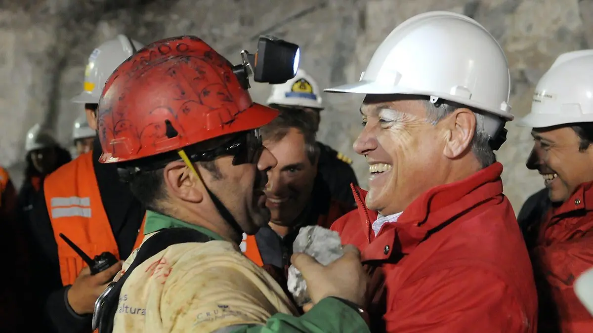 A handout picture released by the Chilean Presidential Office, shows Chilean President Sebastian Pinera (R) as he greets miner Mario Sepulveda after Sepulveda was rescued from the collapsed San Jose gold and copper mine near Copiapo, Chile, 13 October 2010. Sepulveda, 39, is a electrician of the group of 33 miners trapped at the San Jose mine since an accident at the premises on 05 August 2010. EPA/JOSE MANUEL DE LA MAZA / CHILEAN PRESIDENTIAL OFFICE / HANDOUTnull