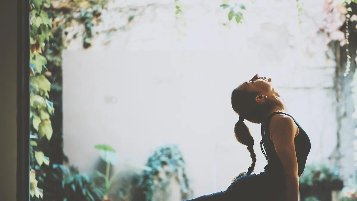 Portrait of gorgeous young woman practicing yoga indoor. Beautiful girl practice cobra asana in class.Calmness and relax, female happiness.Horizontal, blurred background