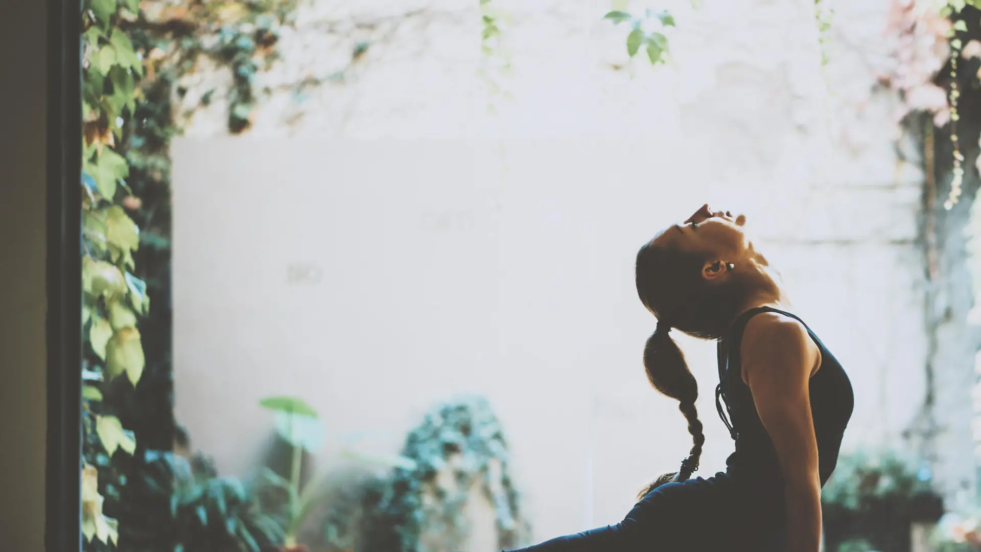Portrait of gorgeous young woman practicing yoga indoor. Beautiful girl practice cobra asana in class.Calmness and relax, female happiness.Horizontal, blurred background
