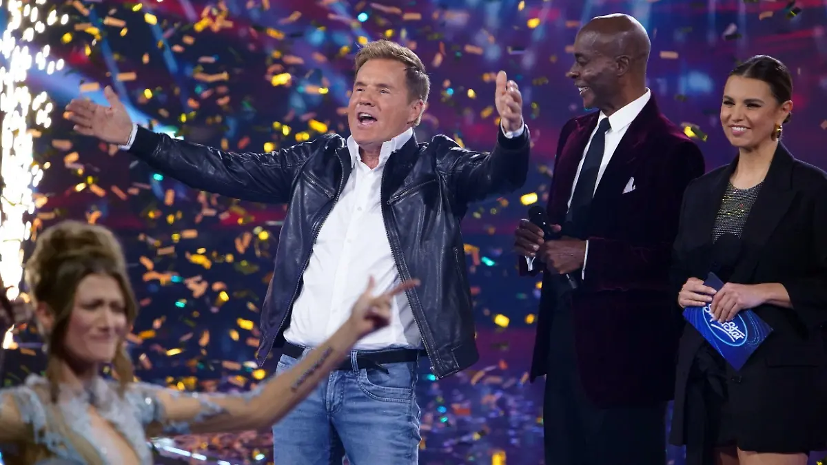 Jurymitglied Dieter Bohlen (l.) verkündet, dass 2024 die Suche nach einem neuen Superstar in eine weitere Staffel geht. In der Mitte Studiogast Bruce Darnell, rechts Moderatorin Laura Wontorra.
Die Verwendung des sendungsbezogenen Materials ist nur mit dem Hinweis und Verlinkung auf RTL+ gestattet.