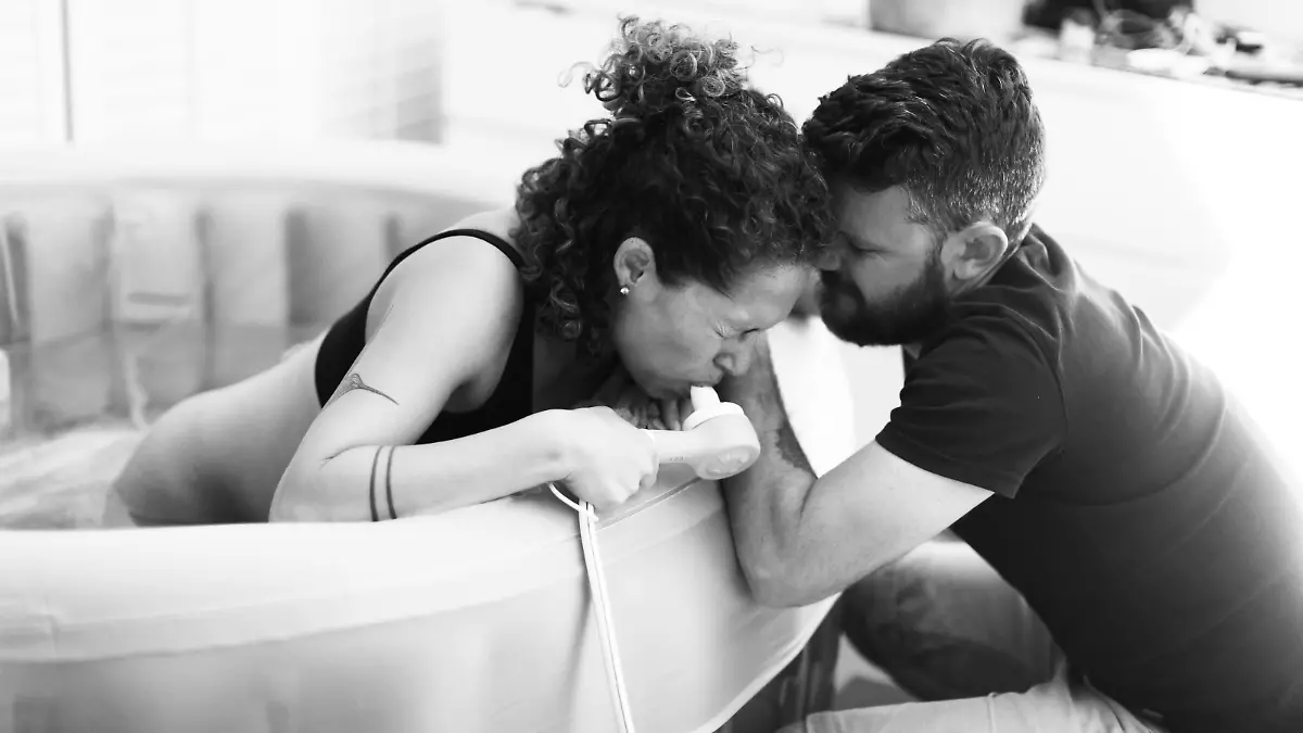 Woman during childbirth at home with husband