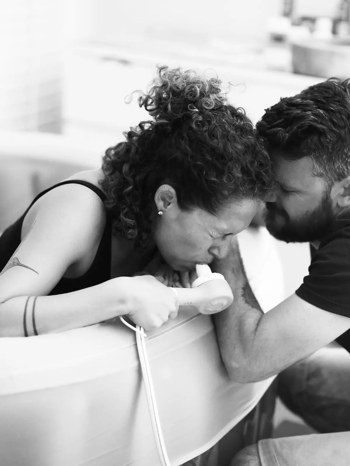 Woman during childbirth at home with husband