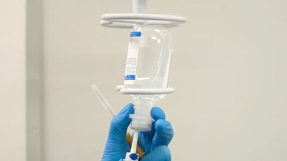 Doctor prepares the system with a dropper and a solution