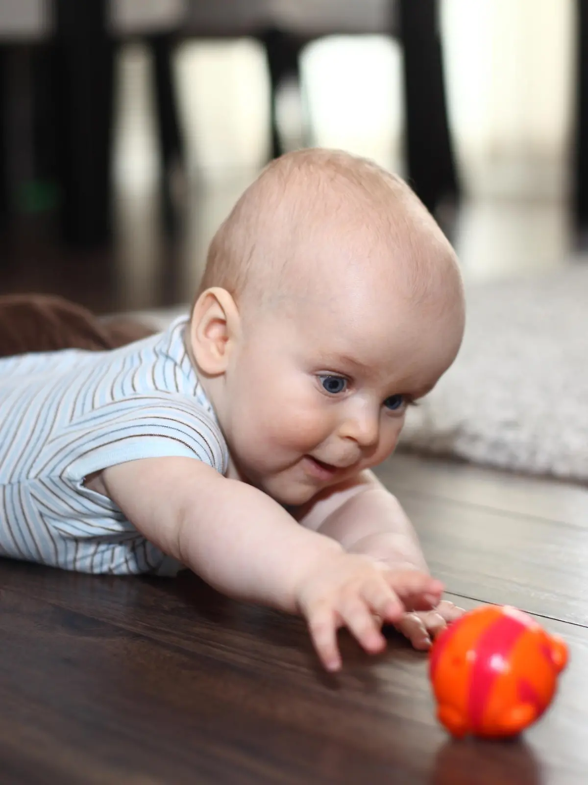 Baby greift nach einem Spielzeug