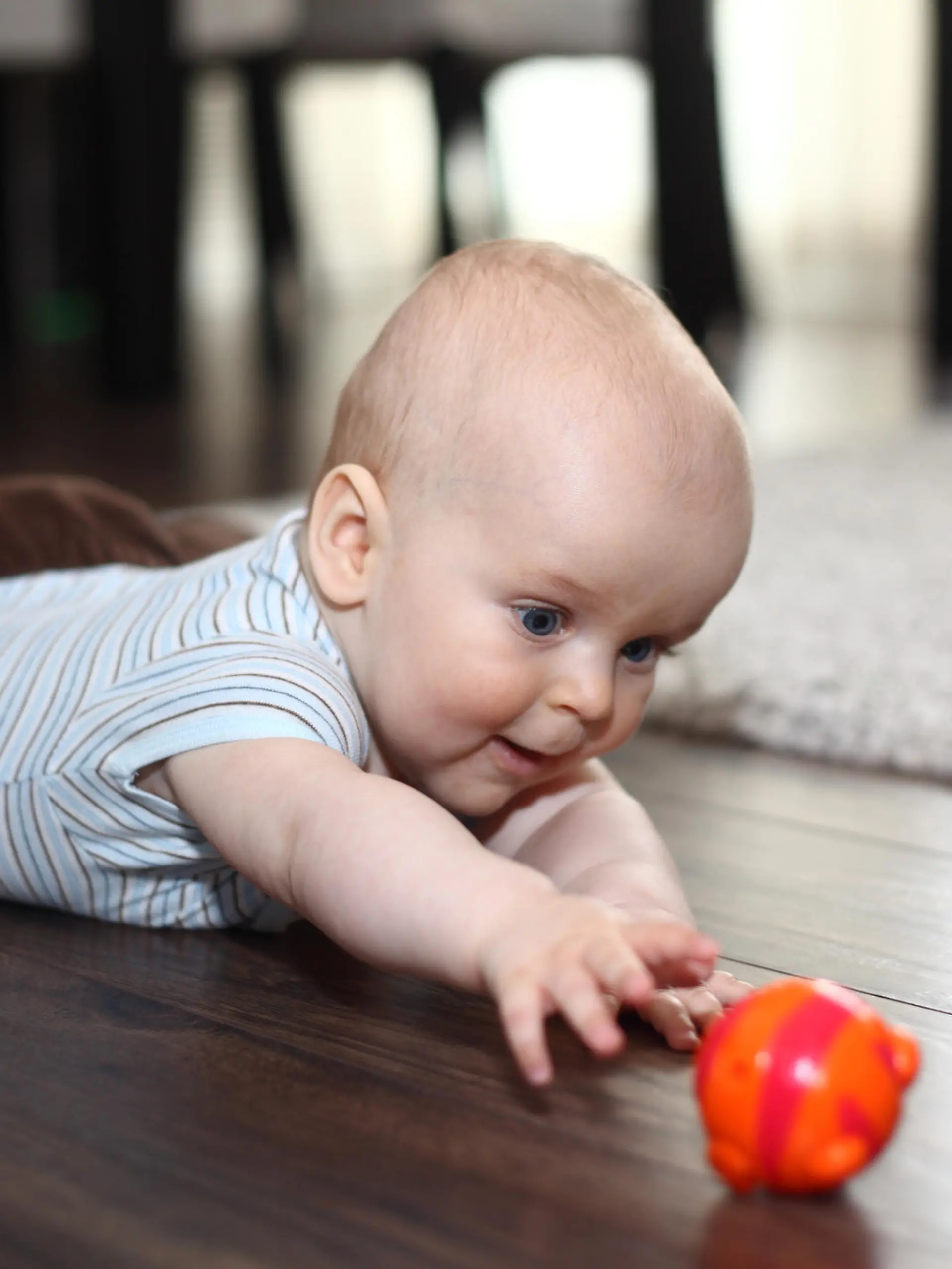 Baby greift nach einem Spielzeug